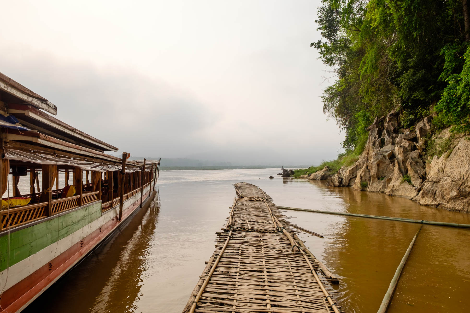 Bamboo pathway on water at Pak Ou cave
